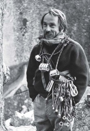 A black and white image of sustainability advocate and Patagonia’s CEO, Yvon Chouinard, dressed in hiking gear.