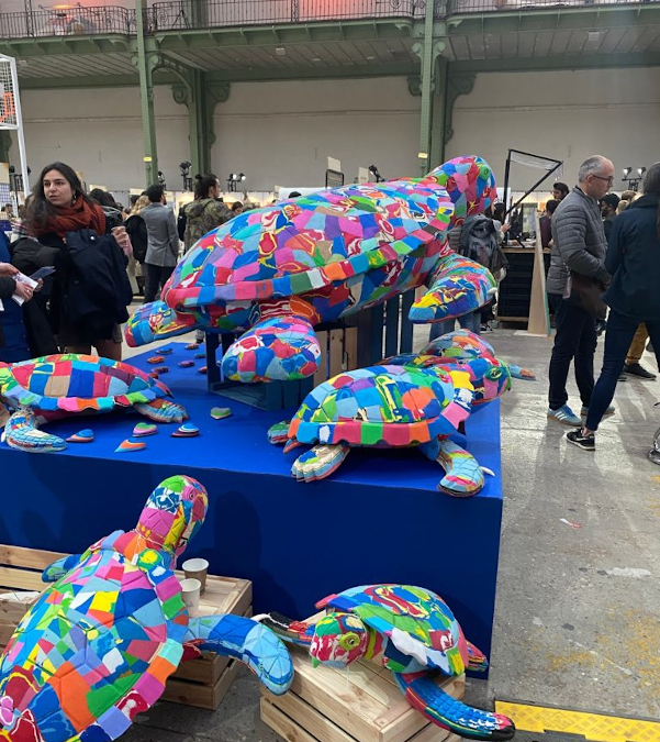 Multicoloured turtles close to the Ocean Cleanup booth at ChangeNOW as symbols of the fauna suffering from pollution caused by humans